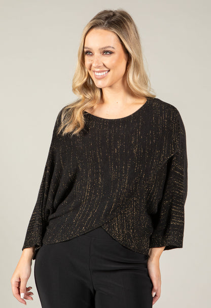 woman wearing an asymmetrical knit top with lurex