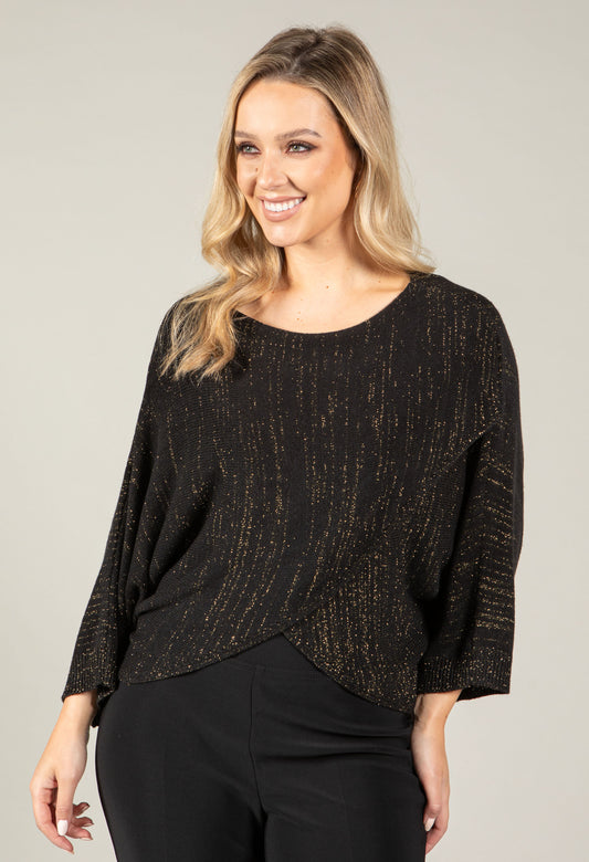woman wearing an asymmetrical knit top with lurex