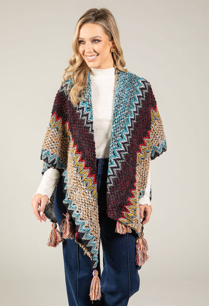 Woman wearing a colorful patterned shawl on a plain background