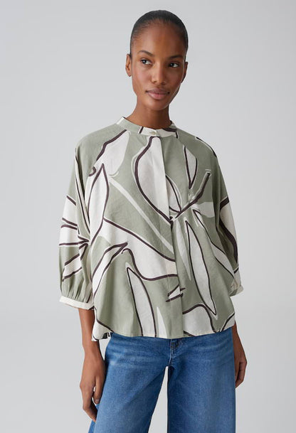 woman wearing a light green printed blouse