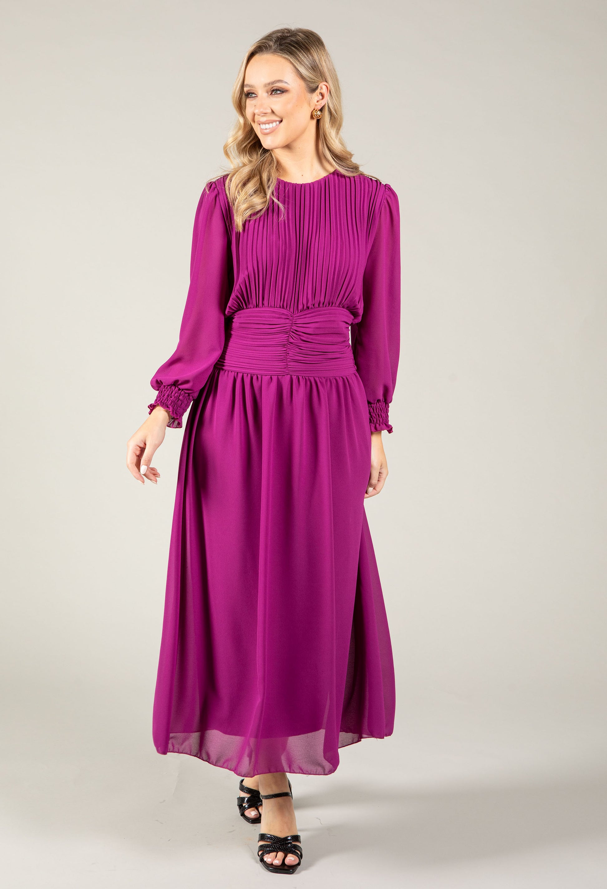 Woman wearing a purple dress on a white background