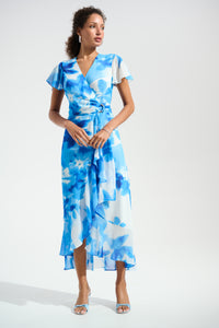 Woman wearing a blue floral dress on a white background