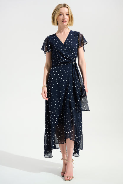 Woman wearing a navy dress with white polka dots on a white background