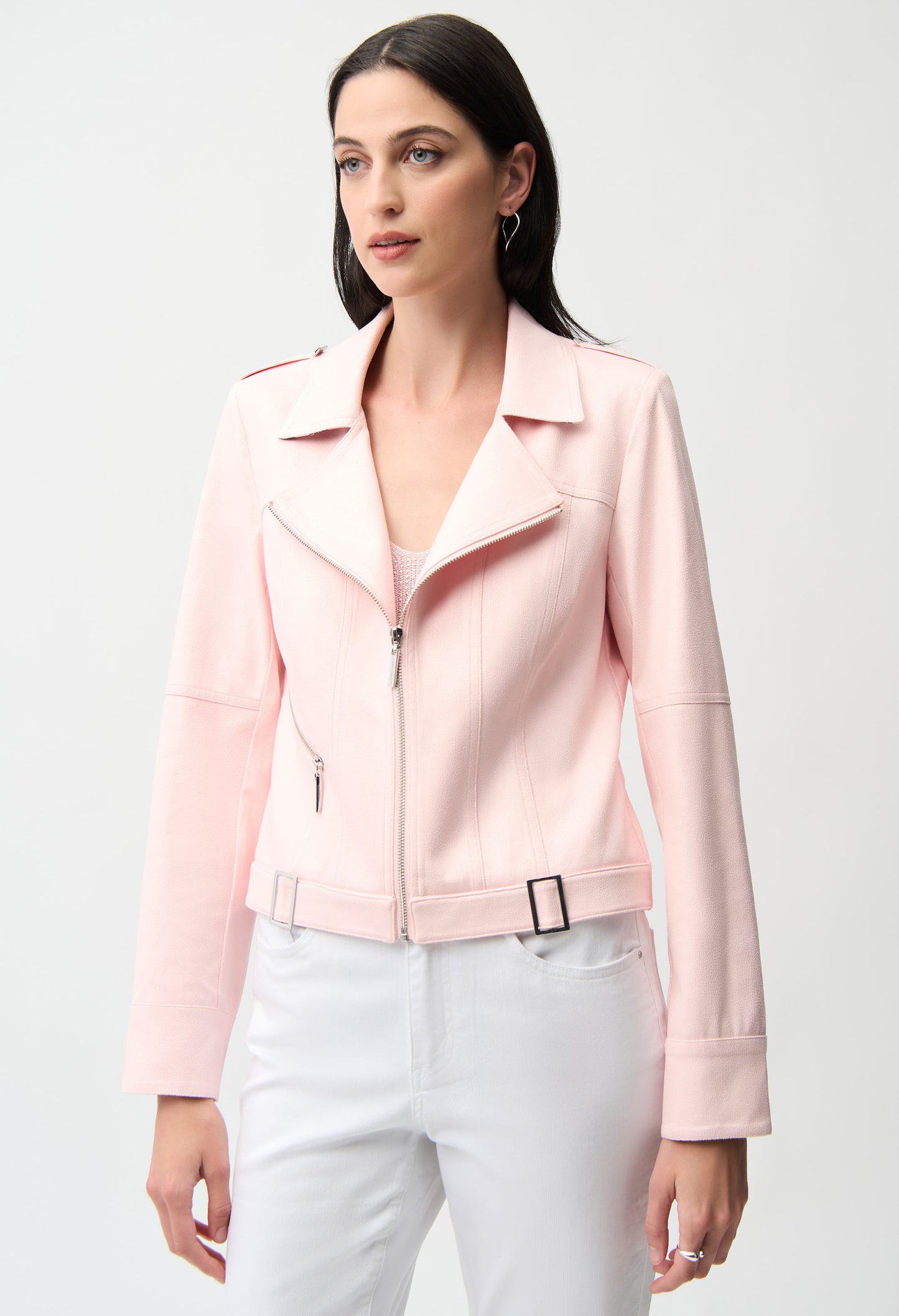 woman wearing a light pink biker jacket on a white background