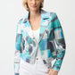 Woman wearing a colorful patterned blazer on a white background
