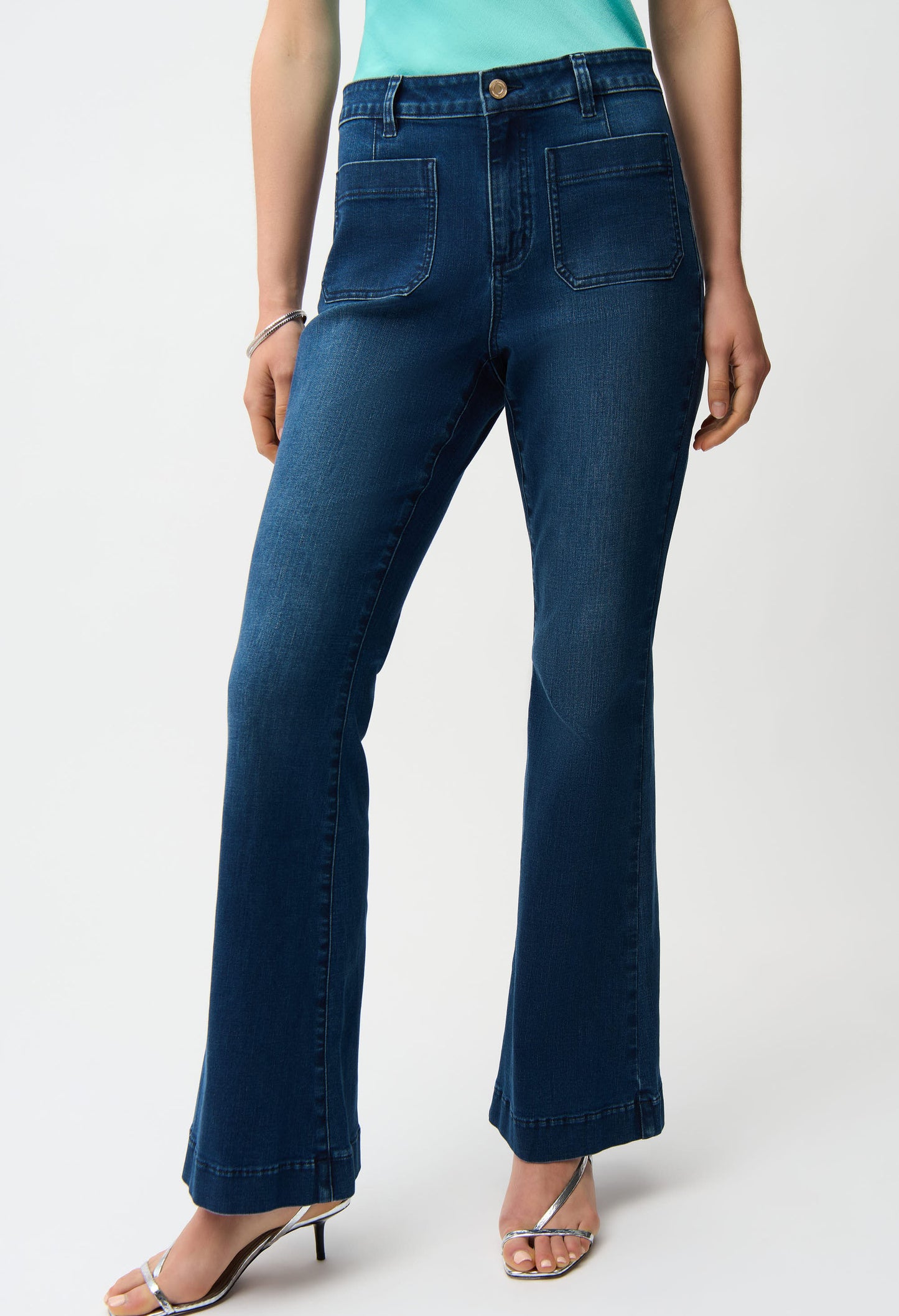 Person wearing blue jeans on a white background