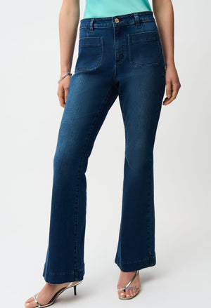 Person wearing blue jeans on a white background