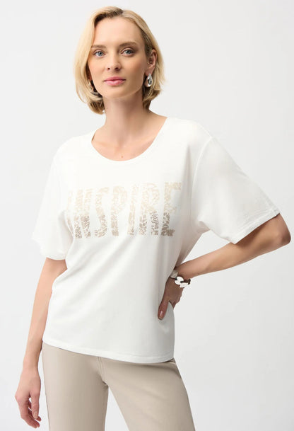 Woman wearing a white t-shirt with text on a plain background