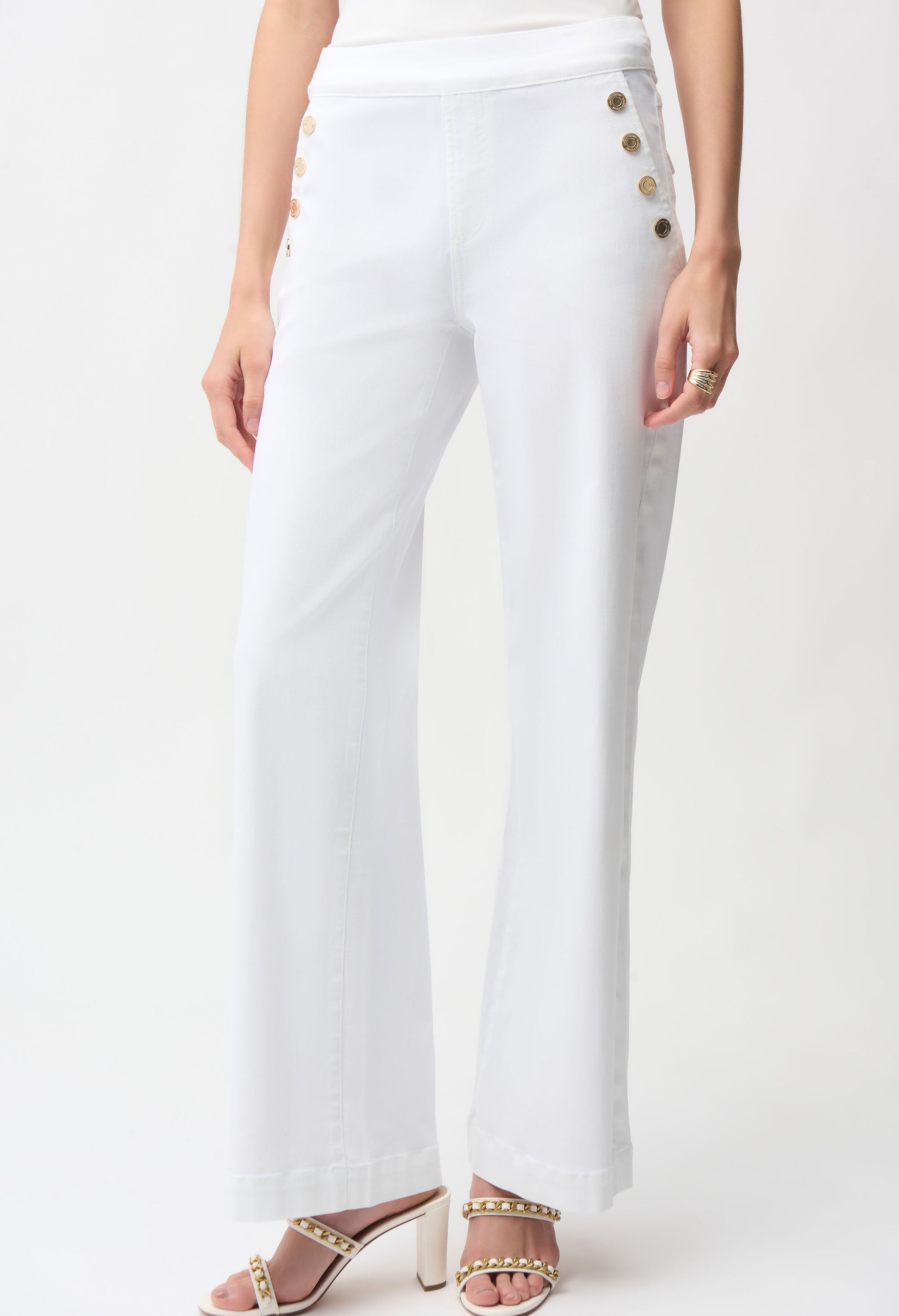 White pants with button details on a white background