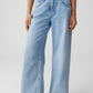 Light blue jeans worn by a person on a plain background