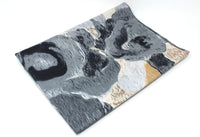 Marble-patterned surface with gray, black, and beige colors on a white background