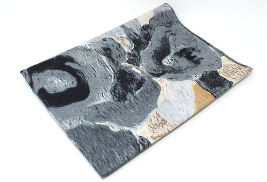 Marble-patterned surface with gray, black, and beige colors on a white background