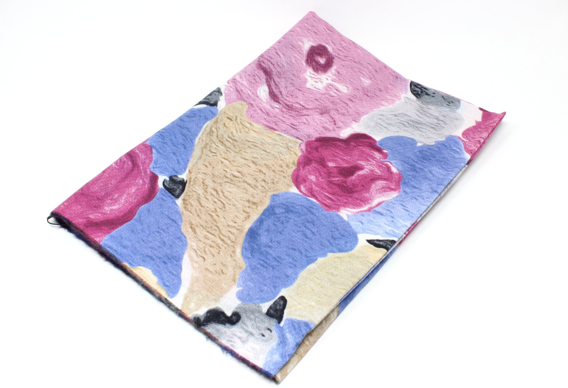 Floral patterned fabric with pink, blue, and beige colors on a white background