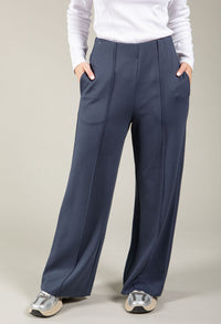 Navy wide-leg pants worn by a person on a plain background