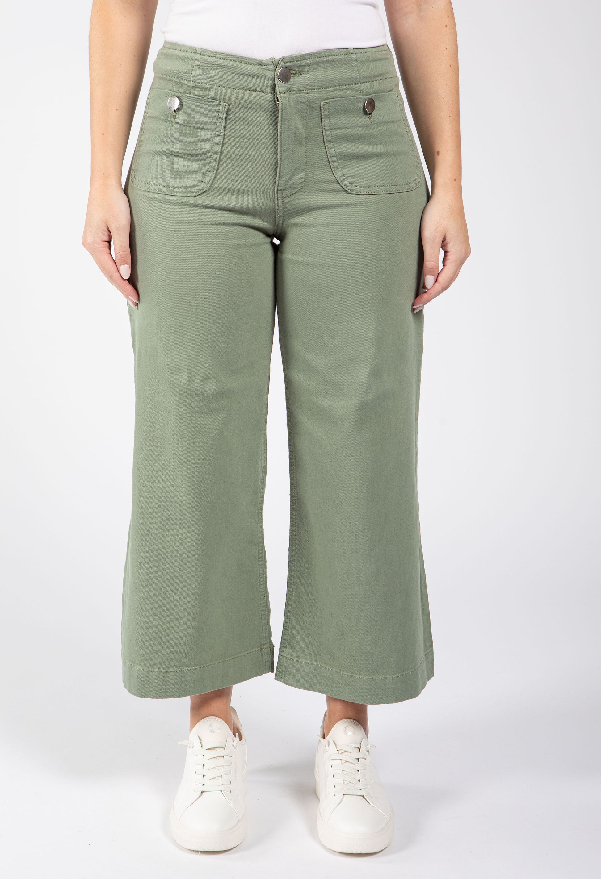 Person wearing green wide-leg pants on a white background
