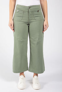 Person wearing green wide-leg pants on a white background
