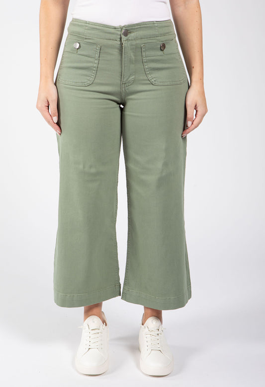 Person wearing green wide-leg pants on a white background