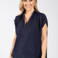woman wearing a navy v-neckline top 
