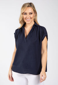 woman wearing a navy v-neckline top 