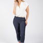 Woman wearing a white blouse and navy pants on a white background