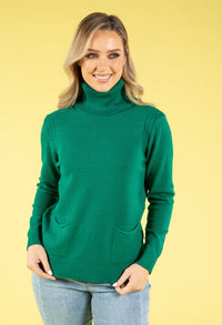 Woman wearing a green sweater against a yellow background