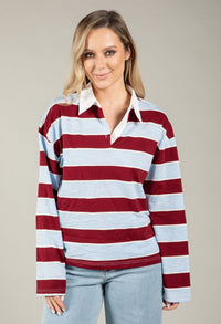 Woman wearing a red and white striped long-sleeve shirt against a plain background