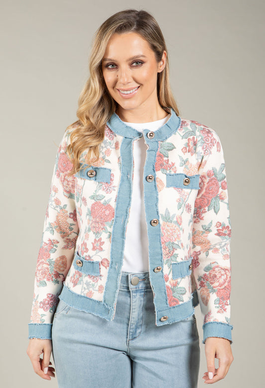 Woman wearing a floral jacket with a neutral background