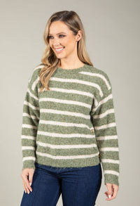 Woman wearing a green and white striped sweater against a gray background