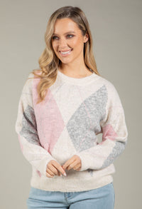 Woman wearing a colorful sweater with a gray background
