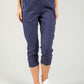 Navy blue jogger pants worn by a person on a light gray background