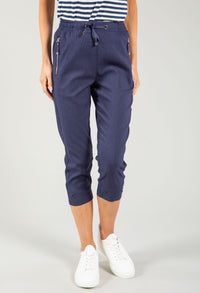 Navy blue jogger pants worn by a person on a light gray background