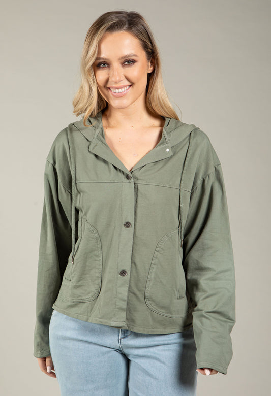 Woman wearing a beige jacket with a plain background