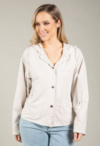 Woman wearing a beige jacket with a plain background