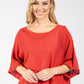 Woman wearing a red blouse against a white background