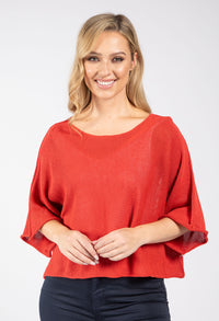 Woman wearing a red blouse against a white background