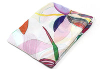 Folded fabric with colorful abstract pattern on a white background