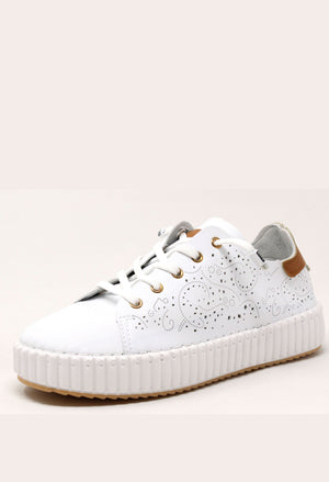 White sneaker with a textured sole on a light beige background