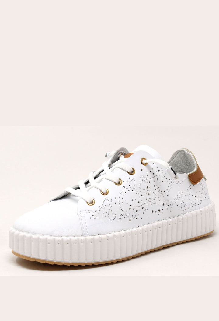 White sneaker with a textured sole on a light beige background