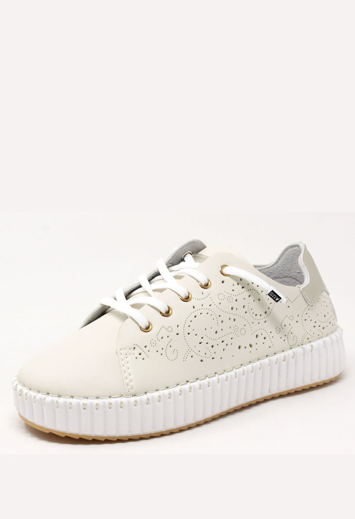 White sneaker with a gray sole on a white background