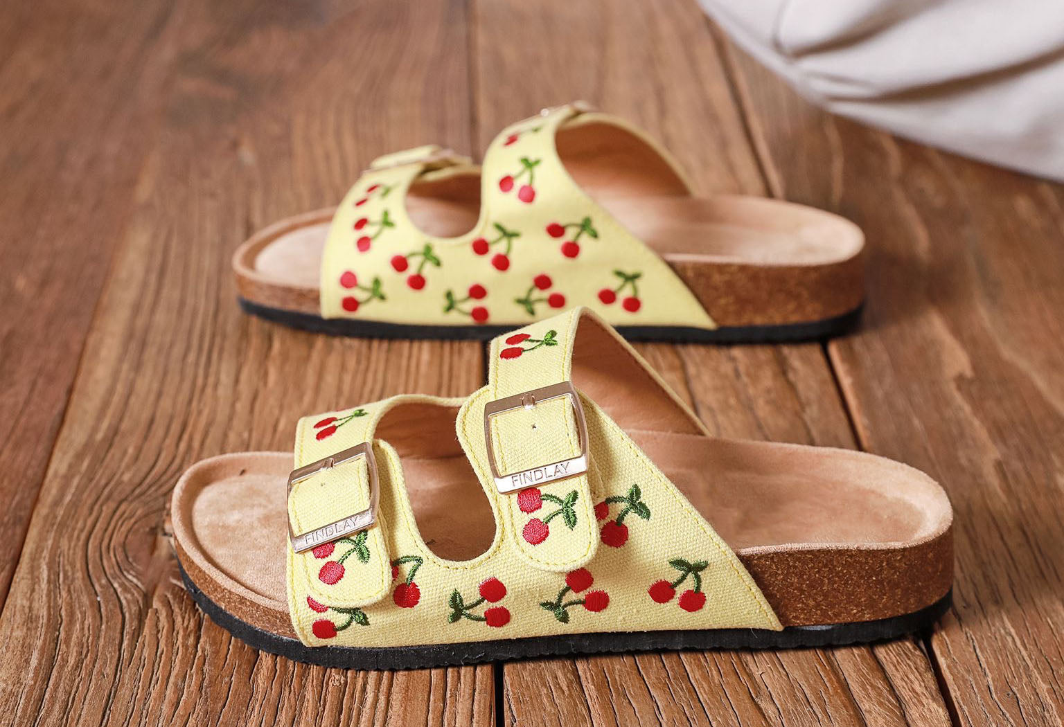 Lemon yellow sandals with embroidered cherry design, double straps and gold buckles