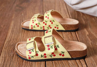 Lemon yellow sandals with embroidered cherry design, double straps and gold buckles