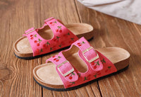 Pink sandals with embroidered cherry design, double straps and gold buckles