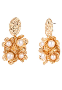 Gold earrings with pearl-like stones on a white background