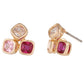 Gold earrings with pink and red gemstones on a white background
