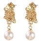 Gold earrings with pearl drops on a white background