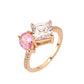 Rose gold ring with pink and clear gemstones on a white background