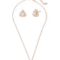 Rose gold necklace and earrings set on a white background