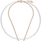 Gold necklace with a pearl pendant on a white background