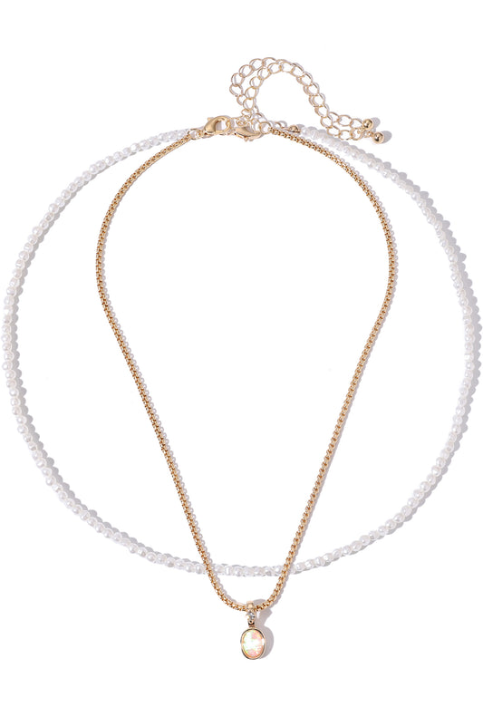 Gold necklace with a pearl pendant on a white background