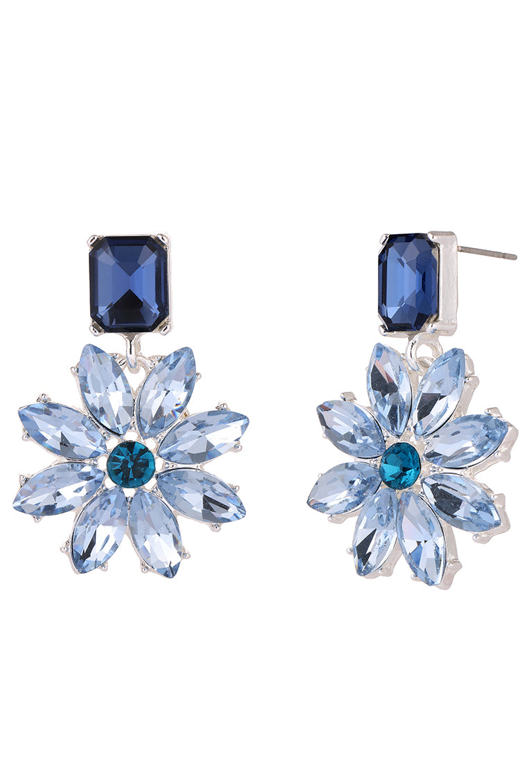 Pair of blue flower-shaped earrings with gemstones on a white background